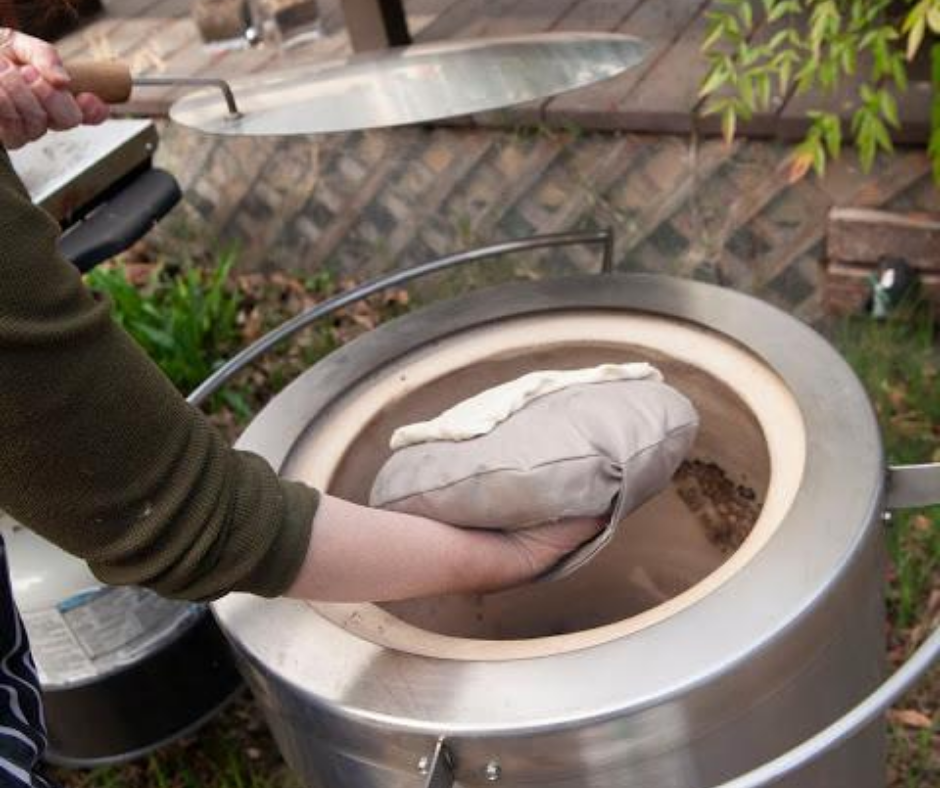 naan being cooked in tandoor oven by hōmdoor